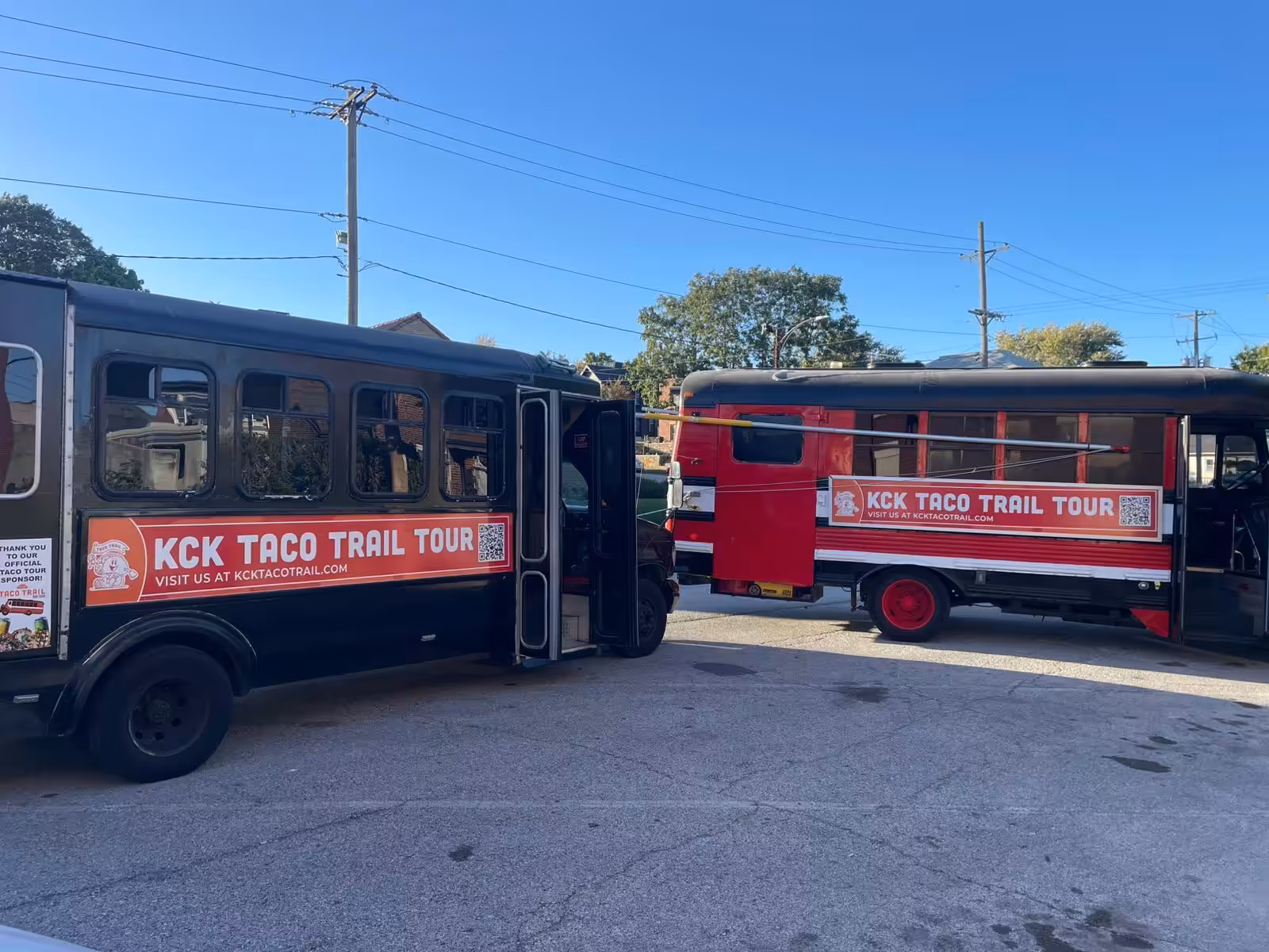 Both Red Machine buses parked side by side Both Red Machine buses parked side by side